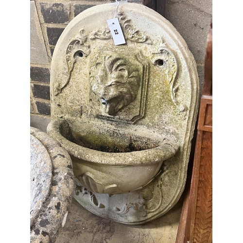 22 - A reconstituted stone garden wall mounted water fountain, with lion mask spout, width 48cm height 70... 