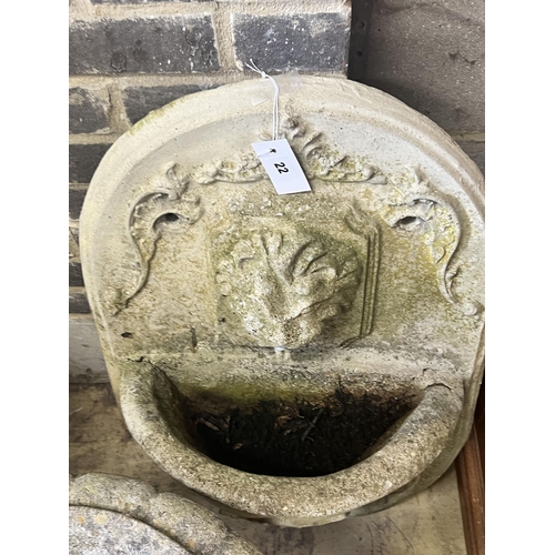 22 - A reconstituted stone garden wall mounted water fountain, with lion mask spout, width 48cm height 70... 