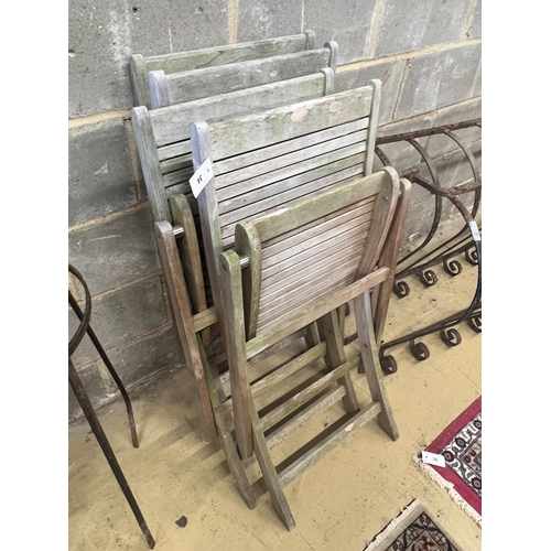 34 - A set of four teak folding garden chairs