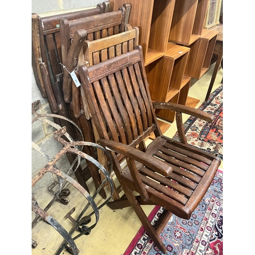 37 - A set of four stained teak folding garden elbow chairs