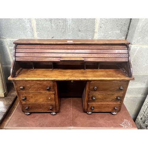 41 - A miniature mahogany and hardwood kneehole tambour desk, width 69cm, depth 22cm, height 45cm.
