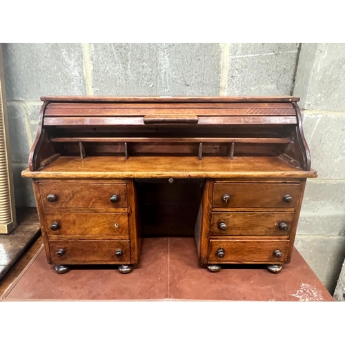41 - A miniature mahogany and hardwood kneehole tambour desk, width 69cm, depth 22cm, height 45cm.