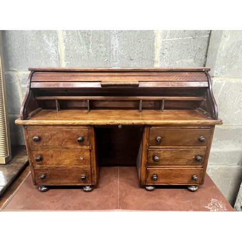 41 - A miniature mahogany and hardwood kneehole tambour desk, width 69cm, depth 22cm, height 45cm.