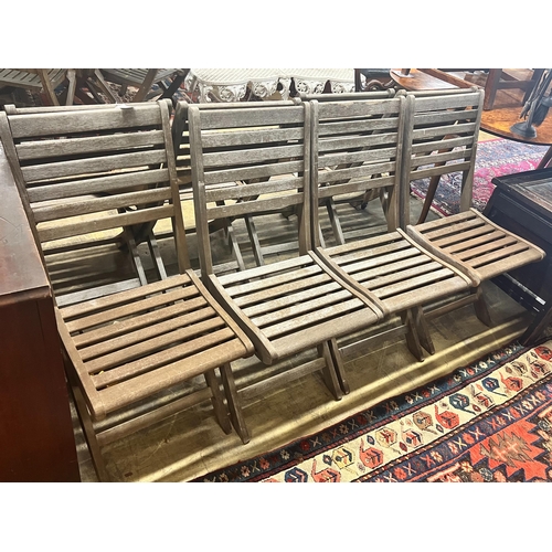 48 - A set of eight teak folding garden chairs