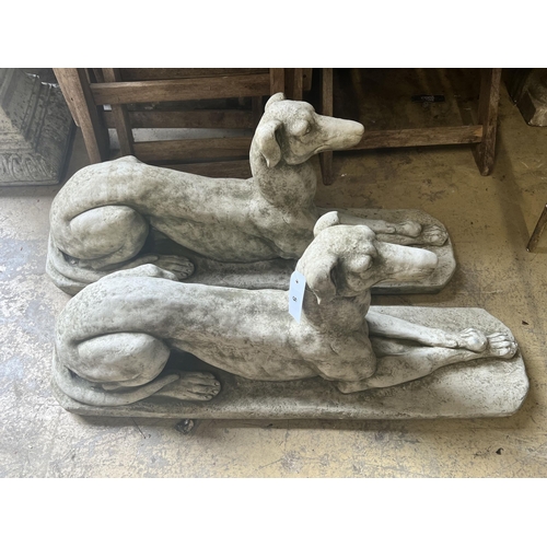 5 - A pair of reconstituted stone recumbent greyhound ornaments, length 82cm