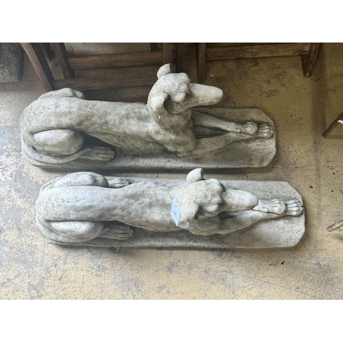 5 - A pair of reconstituted stone recumbent greyhound ornaments, length 82cm