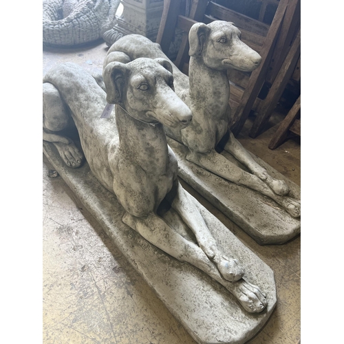 5 - A pair of reconstituted stone recumbent greyhound ornaments, length 82cm