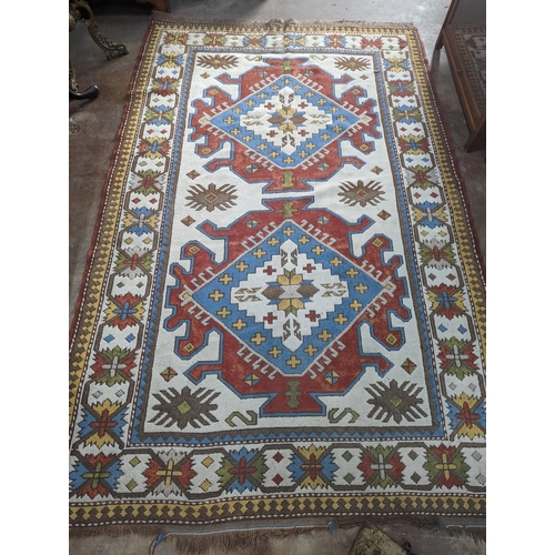57 - A Caucasian design ivory ground carpet, 270 x 170cm