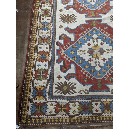 57 - A Caucasian design ivory ground carpet, 270 x 170cm