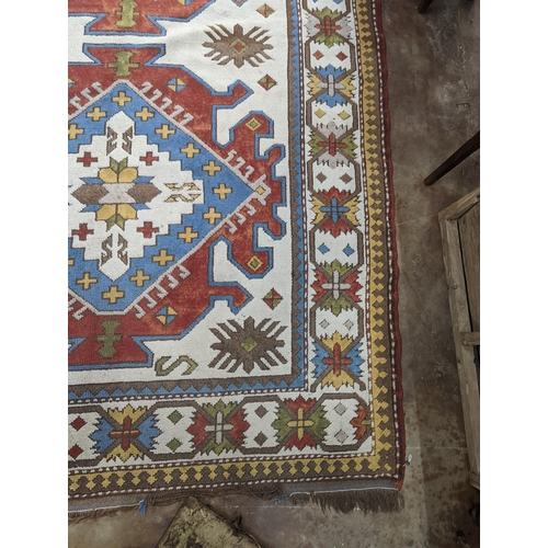 57 - A Caucasian design ivory ground carpet, 270 x 170cm