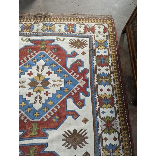 57 - A Caucasian design ivory ground carpet, 270 x 170cm