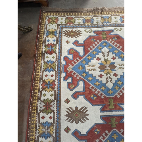 57 - A Caucasian design ivory ground carpet, 270 x 170cm
