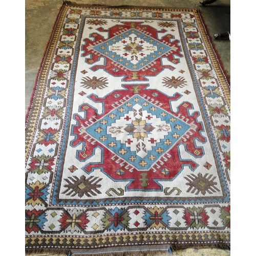 57 - A Caucasian design ivory ground carpet, 270 x 170cm