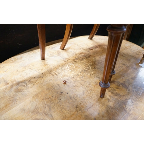 58 - A Victorian burr walnut oval topped dining table, width 120cm, depth 85cm, height 70cm together with... 