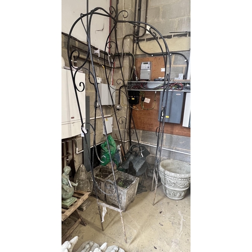 7 - A wrought iron garden arbour, height approx. 250cm