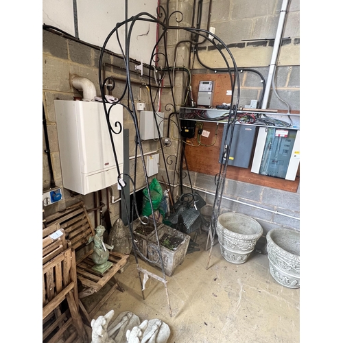 7 - A wrought iron garden arbour, height approx. 250cm