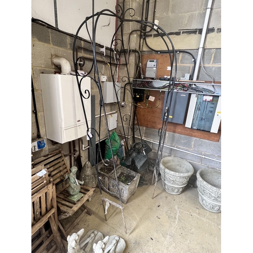 7 - A wrought iron garden arbour, height approx. 250cm