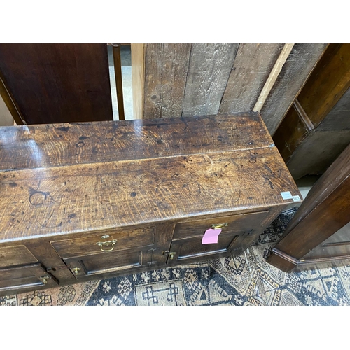 1021 - A late 18th century oak low dresser, the frieze with a small later added drawer, length 157cm, depth... 