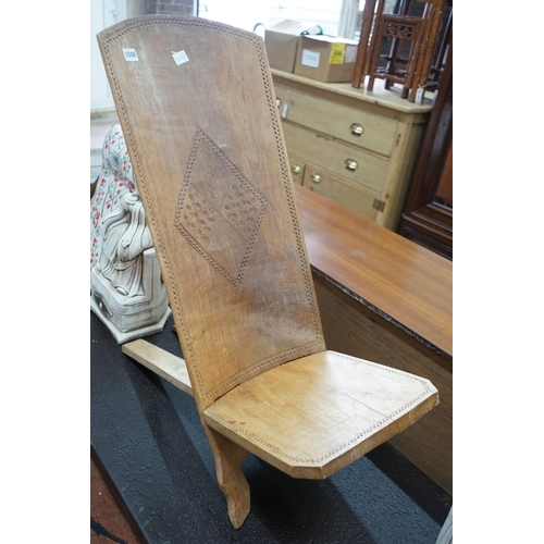 1026 - An African chip carved hardwood seat, height 90cm