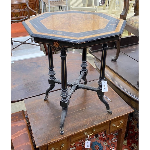 1034 - A late Victorian ebonised and amboyna octagonal centre table, width 56cm, height 64cm