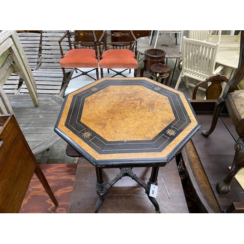 1034 - A late Victorian ebonised and amboyna octagonal centre table, width 56cm, height 64cm