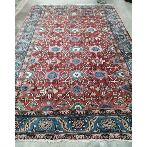 1068 - A Hamadan red ground carpet, 332 x 242cm