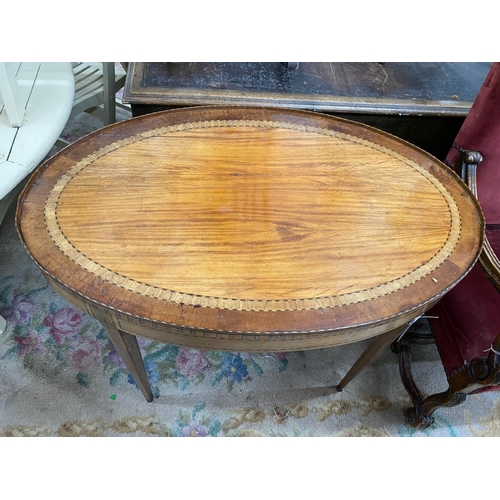 1086 - A George III Sheraton style oval banded satinwood centre table fitted drawer on square tapered legs,... 