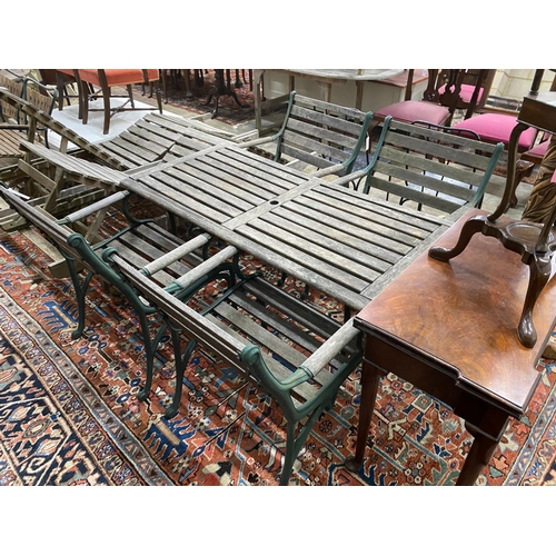 1117 - A rectangular slatted wood and cast metal garden table, length 137cm, depth 67cm, height 64cm togeth... 