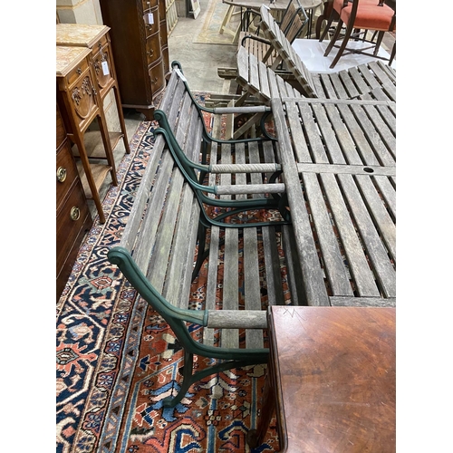 1117 - A rectangular slatted wood and cast metal garden table, length 137cm, depth 67cm, height 64cm togeth... 