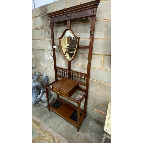 1131 - A late Victorian mahogany hall stand with shield silvered mirror, width 84cm, height 203cm