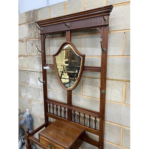 1131 - A late Victorian mahogany hall stand with shield silvered mirror, width 84cm, height 203cm