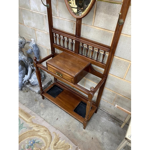 1131 - A late Victorian mahogany hall stand with shield silvered mirror, width 84cm, height 203cm