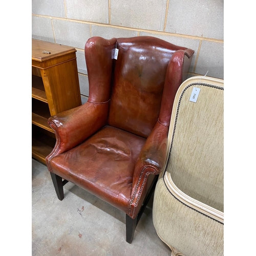 1140 - An antique burgundy leather wing armchair, width 82cm, depth 84cm, height 112cm