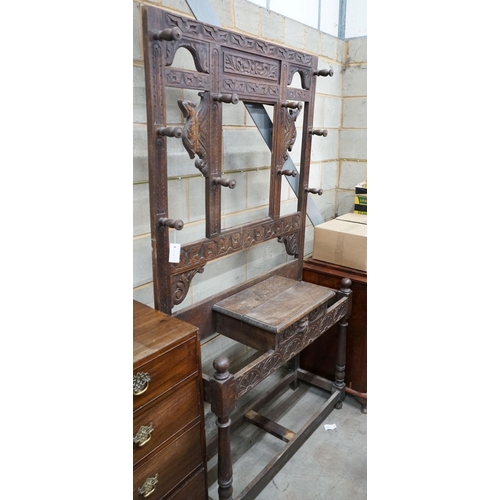 1144 - A late 19th century Flemish carved oak hallstand, width 106cm, depth 36cm, height 198cm