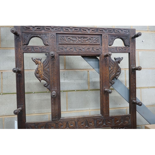 1144 - A late 19th century Flemish carved oak hallstand, width 106cm, depth 36cm, height 198cm