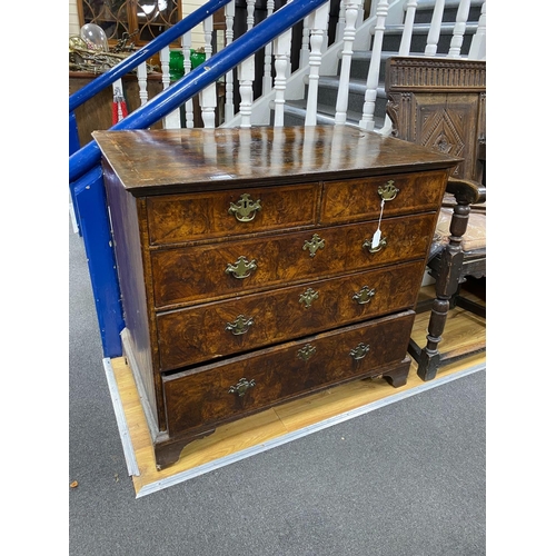 1172 - An 18th century feather banded walnut chest of two short and three graduating long drawers, width 96... 