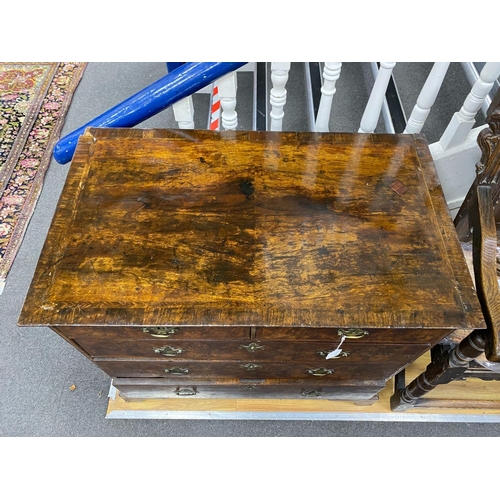 1172 - An 18th century feather banded walnut chest of two short and three graduating long drawers, width 96... 