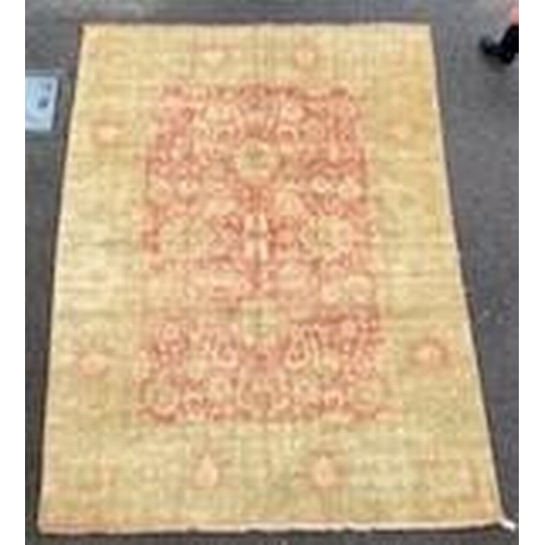 1188 - An Indian Agra carpet, with central field of stylised floral motifs on a red ground within a triple ... 