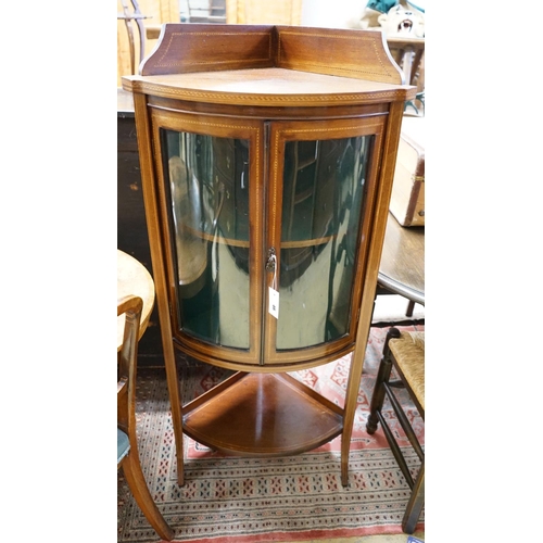 1193 - An Edwardian inlaid mahogany bow fronted standing corner cupboard, width 60cm, depth 44cm, height 13... 