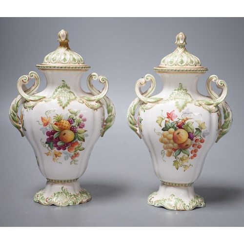 1258 - A pair of Copelands London, fruit decorated two handled vases and covers, circa 1900- 20cms high.... 