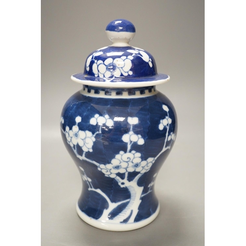 1268 - An early 20th century Chinese blue and white prunus vase and cover, 23cm