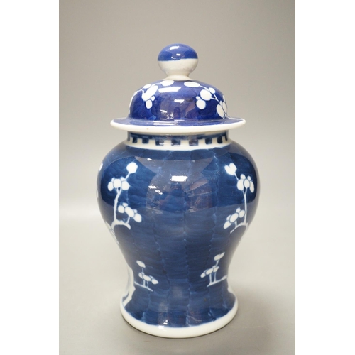 1268 - An early 20th century Chinese blue and white prunus vase and cover, 23cm