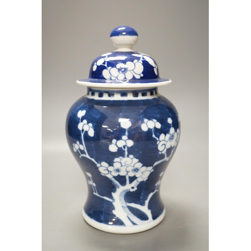 1268 - An early 20th century Chinese blue and white prunus vase and cover, 23cm