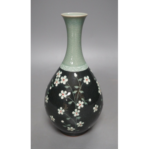 1276 - A Korean celadon ground floral decorated bottle vase, 20.5cm