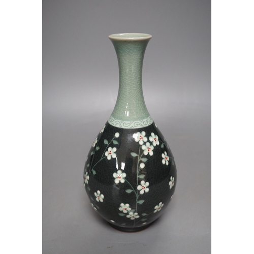 1276 - A Korean celadon ground floral decorated bottle vase, 20.5cm