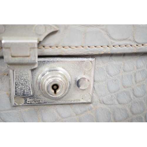 1307 - A pair of blue/grey faux crocodile suitcases