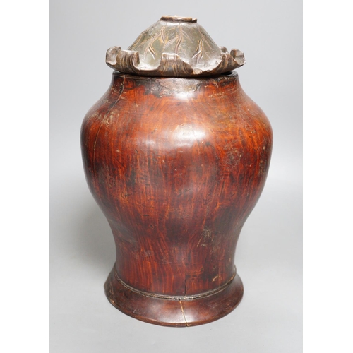 1309 - A Chinese carved wood jar and cover, 33cm