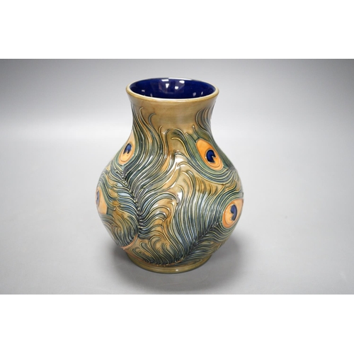 1321 - A Moorcroft pottery vase, decorated with the "Peacock feathers" pattern, 15.5cm