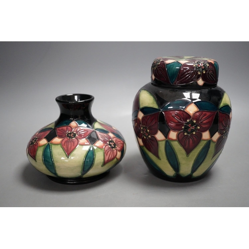 1328 - A Moorcroft pottery squat shaped vase and lidded ginger jar, decorated in the "Orchid Trillium&... 