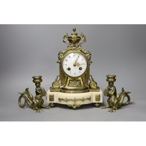 1353 - A 19th century French brass and alabaster mantel clock and a pair of dragon candlesticks,clock 28cms... 